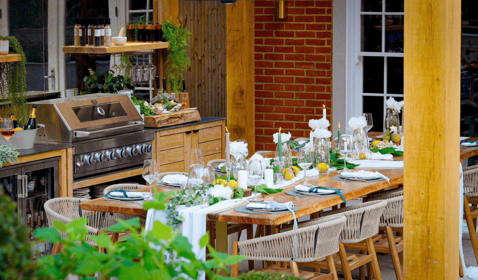 Oak pergola with dining table and outdoor kitchen