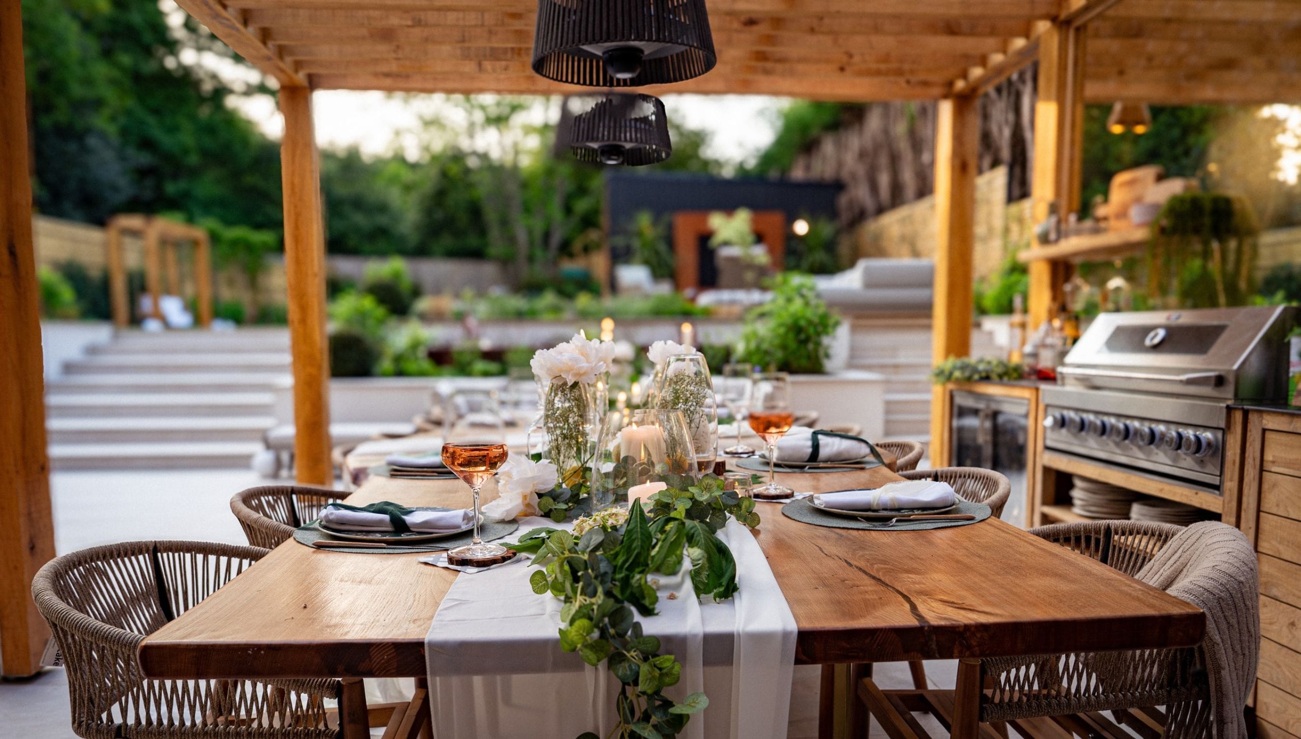 Oak framing pergola with dining table facing garden