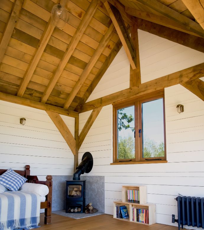 Oak framed boathouse interior with wood burner