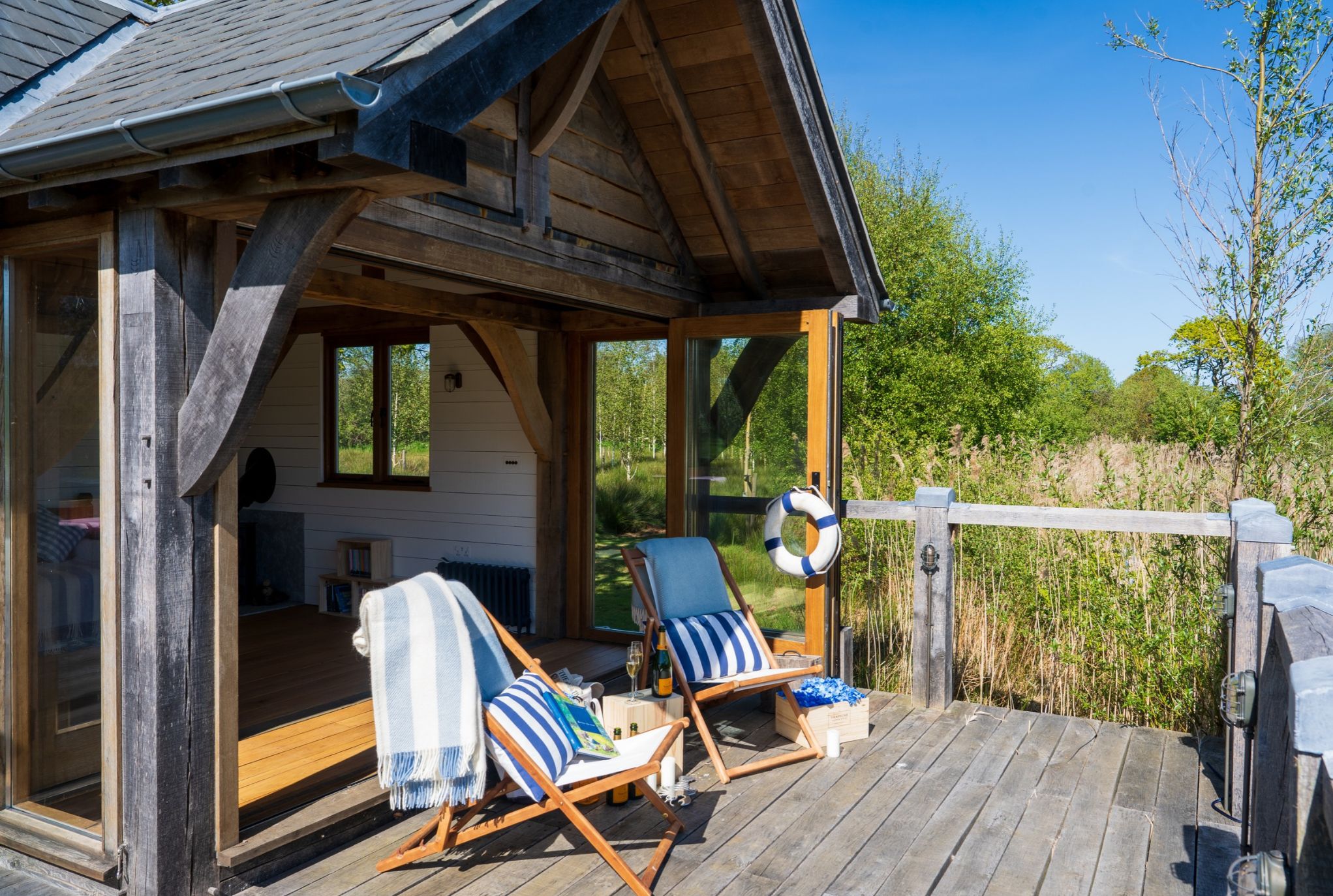 Oak framed boathouse with decking overlooking the lake