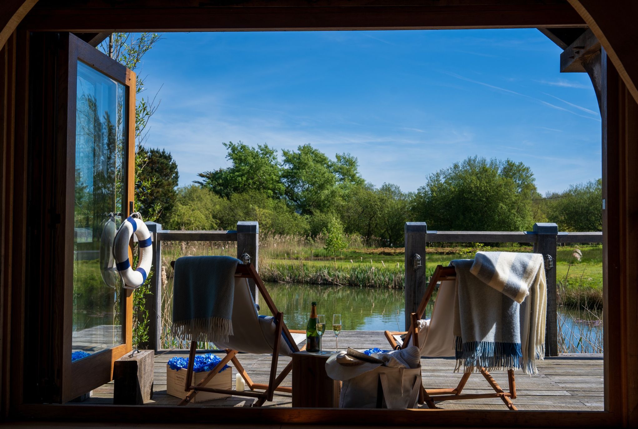 two deckchairs outside oak framed boathouse on the lake in isle of wight